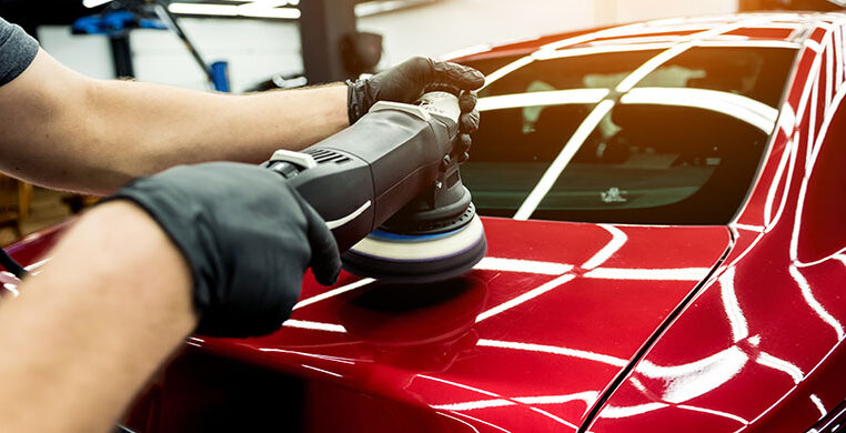 single-services-car-service-worker-polishes-car-details-with-orbital-polisher